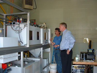 Celina community development consultant Kent Bryan listens as Bob Boyd, a representative from Westech, explains how the treatment system using Orcia Watercare poly-resin particles may help solve problems with Celina's drinking water.<br>dailystandard.com