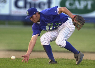 Grand Lake shortstop Doug Kruthaupt tries to field a slow-rolling groundball with his bare hand during the Mariners' game against Portland on Tuesday at Jim Hoess Field. The Mariners committed five errors in a 10-6 loss to the Rockets in an exhibition contest.<br>dailystandard.com