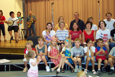 Some current and former members of the DeMange Band provide musical accompaniment as they allow children and grandchildren to take center stage during a rehearsal held last weekend in Versailles. More than 50 family members, ranging in age from 14 months to 63 years, will perform two shows Sunday at the Maria Stein Country Fest.<br>dailystandard.com