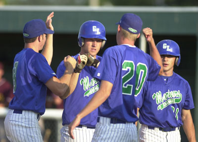 Grand Lake players congratulate John Franzese, middle, after he hit a two-run home run in the bottom of the first inning during Tuesday's game with Indianapolis.<br>dailystandard.com