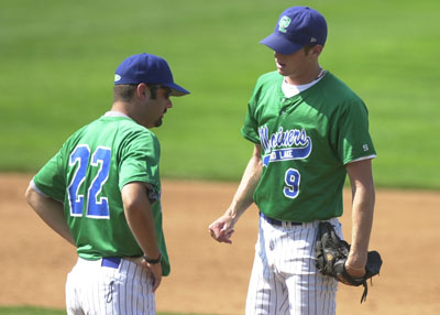 Grand Lake Manager Mike Stafford, 22, talks with pitcher Evan Smith during a playoff game on Monday in Columbus at Bill Davis Stadium. The Mariners split two games on Monday losing the opener, 7-4, against Columbus and then defeating Stark County, 4-3.<br>dailystandard.com