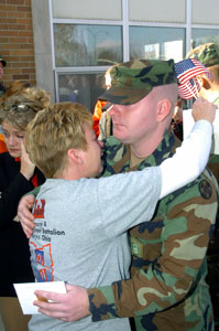 Sandra Lockhard tearfully embrasses her son, Brooks Turner, <br>shortly before he boarded one of three chartered buses that will take him and his <br>soldier-comrades to Camp Atterberry, Indiana for a few weeks training before deploying to Iraq. The newspaper picture will be 