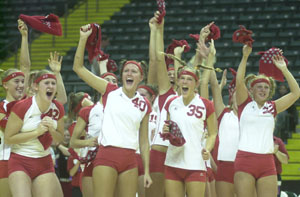 St. Henry's Brittany Post, 42, Cami Lefeld, 40, Christa Schwartz, 35 and Maria Wuebker, 22, celebrate with teammates after the Redskins won the Division IV state volleyball title on Saturday with a three-game win over Norwalk St. Paul.<br>dailystandard.com