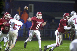 St. Henry quarterback Nate Stahl, 8, throws the ball downfield during Saturday's Division V state semifinal against Patrick Henry at Bath High School. Stahl didn't have to throw much in the poor weather as the running game and defense carried the Redskins to a 13-0 victory.<br>dailystandard.com