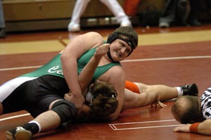 Celina's Sam Eshelman holds on to Wapakoneta's James Byrne long enough for the referee, right, to signal the pin during the 275-pound bout on Tuesday at Wapak.<br>dailystandard.com