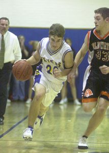 Marion Local's Curtis Moeller, left, pushes the ball up court as Coldwater's Brent Robbins, 33, tries to defend. Moeller had six points in the Flyers' 39-38 win.<br>dailystandard.com