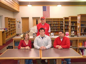 St. Henry defensive lineman Kalen Hemmelgarn will play football next fall for the University of Dayton. Seated with Kalen are parents Sue and Bill Hemmelgarn and St. Henry coach Jeff Starkey is standing in the back.<br>dailystandard.com