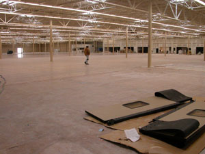 A lone worker walks across the vast inside of the Wal-Mart Supercenter in Celina. It is about 205,000 square feet and scheduled to open May 11.<br>dailystandard.com
