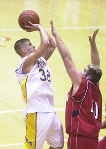 St. Marys' Wes Clark, 32, shoots over a Wauseon defender during their Division II district semifinal contest on Wednesday. Clark scored a game-high 23 points to lead the Roughriders to a 68-42 win.<br>dailystandard.com