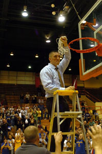 St. Marys head coach Josh Leslie finishes cutting down the net after the Roughriders defeated Van Wert, 60-57 in overtime on Saturday night at Anderson Arena on the campus of Bowling Green State University.<br>dailystandard.com