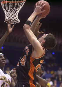 Andy Beckman, 24, goes up strong to the hoop. Beckman had just two points but pulled down nine big rebounds to help Minster.<br>dailystandard.com