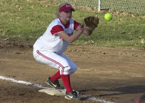 St. Henry's Kylie Elking covers first base on a Celina bunt attempt during Monday's contest. Celina won, 2-1.<br>dailystandard.com