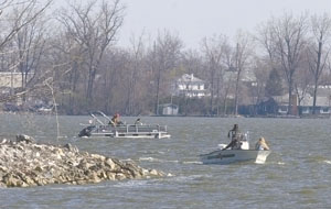 Two boats, part of a group of seven that departed West Bank State Park as a 10:30 a.m. memorial service began across town, head for open water to resume the search for Greg Parker, 15, of Celina, and Jonas Kahlig, 15, of Coldwater. Their boat apparently capsized a week ago after they set out to fish and later meet friends.<br>dailystandard.com