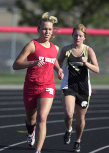 St. Henry's Stacy Goettemoeller, left, runs ahead of Parkway's Audrey Linn, right, during Thursday's quadrangular meet at St. Henry's Wally Post Athletic Complex.<br>dailystandard.com