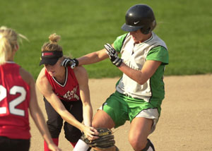 Celina's Kinsey Schumann, right, gets to second base safely as a Kenton defender drops the ball during their game on Tuesday. The Bulldogs won the game handily, 10-0 in five innings.<br>dailystandard.com