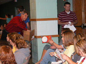 Celina High School teacher Bill Sell helps distribute a free smoke detector to each senior at the school as part of a fire prevention program by the Celina Fire Department. Grant funds enabled the local firefighters to educate the college-bound seniors about fire prevention and safety in dormitories and off-campus housing.<br>dailystandard.com