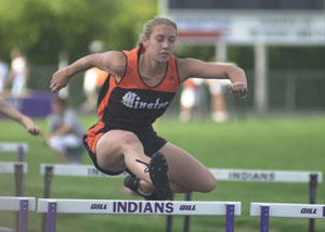 Minster's Kacie Otting, clears a hurdle during the Midwest Athletic Conference meet two weeks ago. Otting was the lone individual winner for the Wildcats in the Division III district meet held at Minster on Saturday, winning the 100-meter hurdles helping Minster to the team title.<br>dailystandard.com