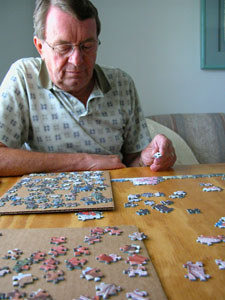 Paul Bills hunts for the right fit for the 1,000-piece puzzle, 