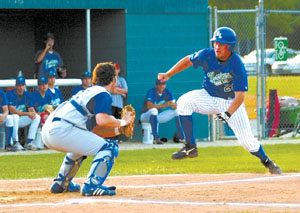 Grand Lake's Kurt Lauscher, 28, tries to elude Delaware catcher Joe Ryback's tag during Wednesday's game at Jim Hoess Field.<br>dailystandard.com