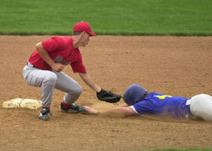 Van Wert's Kody Heppeard, left, tags out St. Marys' Koby Frye during their district ACME contest at St. Henry's Wally Post Athletic Complex on Thursday. Van Wert knocked St. Marys out of the ACME tournament with an 11-4 win.<br>dailystandard.com
