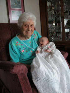 Georgiana Meiring of Fort Recovery cuddles with great-granddaughter Megan Knapke, who is wearing the same baptismal gown worn by Meiring 89 years ago.<br>dailystandard.com