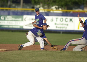 Grand Lake's Bryant Witt makes a tag on a Lima runner as teammate Dusty Hammond, 3, backs up the play. The Mariners begin GLSCL tournament play on Wednesday in Columbus.<br>dailystandard.com