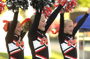 Minster Junior High School cheerleading squad performs a routine for a crowd Monday night during the cheerleading competition at the Auglaize County Fair. The squad won second place, with St. Henry winning first and Waynesfield third in the junior high division. <br>dailystandard.com