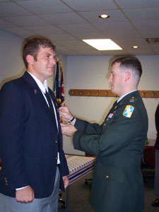 U.S. Army Capt. David Shapiro pins the Purple Heart badge on Kevin Fennig of Celina during a special ceremony Sunday, which was National Purple Heart Day, a day set aside to recognize the 1,535,000 recipients of the Purple Heart. <br>dailystandard.com