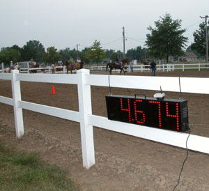 A digital clock temporarily hanging on the fence of the horse arena at the Mercer County Fairgrounds. The new clock will be used for all horse contests at the fair in memory of Shaffer.<br>dailystandard.com