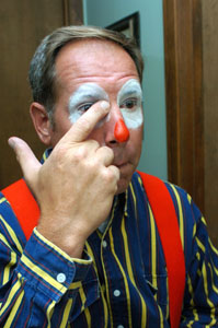 Terry Humphries, president of  St. Marys Veterans of Foreign Wars Post 9289 Clown Unit, applies makeup for an appearance. The unit, organized in 1971, was once the only known VFW organization of its kind in the world. Members voted in June to disband. Their final appearance is at Saturday's St. Marys Summerfest Parade.<br>dailystandard.com