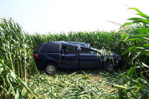A heavily damaged van sets in the midst of a cornfield following a three-vehicle accident Friday afternoon at the intersection of Fairground and Fleetfoot roads. All four occupants of the vehicle -- a Coldwater man and three girls -- were injured including one who required emergency helicopter transport to a Dayton hospital.<br>dailystandard.com