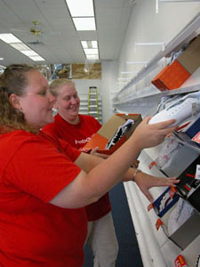Shoe Show Manager Jennifer Hardin, left, and assistant manager Aimee Westgerdes begin stocking items at the store's new location in Harbor Square in Celina. The retail store is one of three moving across the road from Lakewood Village Center to neighbor near the Wal-Mart Supercenter.<br>dailystandard.com