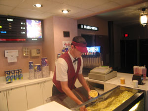 An employee at the Celina cinemas serves popcorn to the few people attending the movies Thursday. National reports have said movie attendance has been down. <br>dailystandard.com