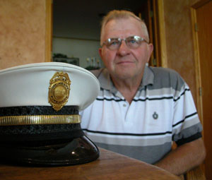 Leroy Rutschilling is pictured with his treasured fire chief hat from his days with the St. Henry Fire Department. The department is celebrating its 100th year Sunday.<br>dailystandard.com