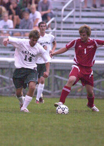 Celina's Aaron Schmitt, 14, chases down the ball in front of a Kenton defender during their match on Monday night. The score ended up in a 1-1 tie after the game was called due to lightning following the first half of action.<br></br>dailystandard.com