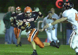 Coldwater's Justin Kahlig, 8, races away from a Minster defender for a touchdown reception during their Midwest Athletic Conference contest on Friday night. Coldwater scored 28 points i the first half and went on to beat Minster, 48-7.<br></br>dailystandard.com