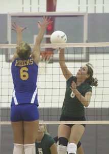 Celina's Kylie Dorsten, right, tries to hit the ball past St. Marys' Alyssa Ahlers, 6, during their Division II sectional final contest at Lima Senior High School on Tuesday night. Celina defeated St. Marys in three games, 25-18, 25-15 and 25-21.<br></br>dailystandard.com