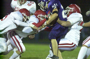 A trio of St. Henry defenders bring down a Fort Recovery ball carrier during their game on Friday night. St. Henry defeated Fort Recovery, 48-13.<br></br>dailystandard.com