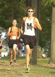Minster's Casey Heckman, front, runs in front of Coldwater's Jamie Kuess, back, during the Coldwater Invitational held earlier this fall sports season. Heckman and Kuess will be running at the Division III state cross country meet on Saturday at Scioto Downs.<br></br>dailystandard.com