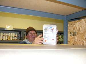 Clyde McCune, a volunteer at CALL Food Pantry in Celina, places a lone bag of flour on the shelf inside the Main Street office. Supplies are dwindling locally due to a large amount of government aid going to hurricane victims and an increase in the number of people eligible for assistance in Ohio.<br></br>dailystandard.com
