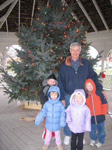 Dave Bensman of Minster and some of his grandchildren stand near the Colorado blue spruce that was planted 15 years ago as a seedling. Bensman and his wife, Margie, donated the tree to the village of Minster for use in its Christmas display.<br></br>dailystandard.com