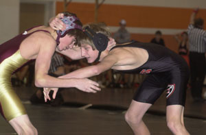 Coldwater's Brock Timmerman, right, tries to grab hold of Edgerton's Mike Brown, left, during their 112-pound match in a preliminary on Saturday at Coldwater's Bob Sielski Memorial Duals on Saturday.<br></br>dailystandard.com