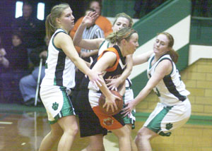 Minster's Nikki Wente, with ball, gets surrounded by Celina's Liz Homan, left, Meg Smalley, back, and Betsy Hone, right, during their nonconference game on Saturday afternoon. Minster went on to defeat Celina, 43-38.<br></br>dailystandard.com