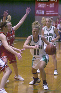 Celina's Meg Smalley, 11, tries to dribble around the Kenton oncoming double team during Thursday's Western Buckeye League game at the Fieldhouse. Celina defeated Kenton, 62-45.<br></br>dailystandard.com