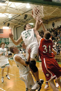 Celina's Brian Gagle, 23, goes strong for a rebound with Shawnee's Jimm Nickels, 31, during their Western Buckeye League game on Friday night. Celina's Justin Chapel, back left, and Eric Loughridge, front left, watch on during the play.<br></br>dailystandard.com