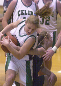 Celina's Kelsey Waterman, left, rips the ball out of a Greenville players hands during their game on Saturday. The Bulldogs defeated the Green Wave, 62-45.<br></br>dailystandard.com