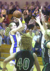 Marion Local's Maria Moeller, with ball, shoots in front of Celina's Betsy Hone, top right, and Laura Link, middle right, during their game on Tuesday night. Marion Local won, 42-33.<br></br>dailystandard.com
