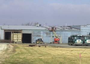 Construction workers start to dismantle the old Star Warehouse south of Celina. The site will be the location of the new Bud's car dealership.<br></br>dailystandard.com