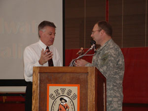 Coldwater head football coach John Reed, left, accepts the MaxPreps.com trophy from Ohio Army National Guard Brigadier Gen. Matt Kambic during a Monday assembly at The Palace. Coldwater finished the season ranked 15th in the nation by MaxPreps.com, the second-highest rank for an Ohio team in 2005.<br></br>dailystandard.com