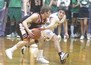 Celina's Derek Gagle, right, reaches in on Coldwater's Brady Geier, with ball, during their Mercer County showdown on Saturday night at the Fieldhouse. Coldwater defeated Celina 63-53.<br></br>dailystandard.com